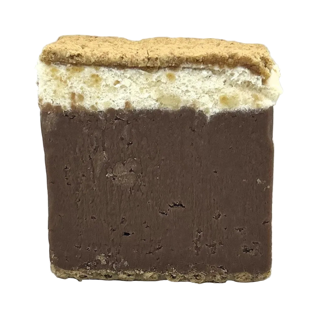 A S'mores dessert consisting of a chocolate fudge layer, white chocolate marshmallow, and graham cracker crust.